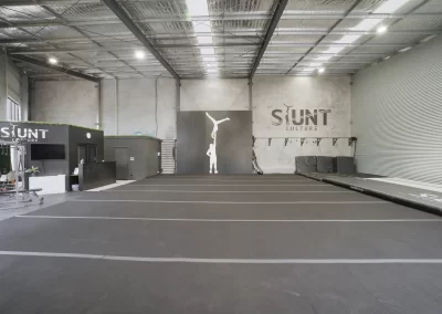 Commercial warehouse gym interior with steel frame construction and large open-plan industrial building