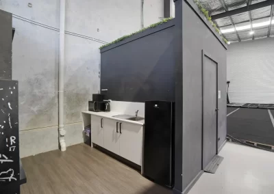 a minimalist black kitchenette